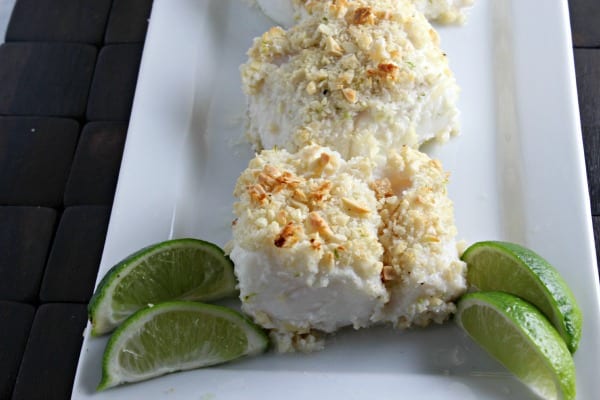 Baked Cod goes from ordinary to extraordinary when it melds with coconut, almonds and a hint of lime. This Coconut Almond Crusted Cod recipe from CookingInStilettos.com will be a family favorite! | Cod Recipes | Coconut | Seafood | Baked Fish | Easy 30 Minute Recipe | Tropical Recipe