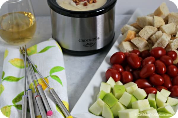 Have a last minute soiree - host a Wine and Easy Cheese Fondue party. This Easy Cheese Fondue from CookingInStilettos.com comes together in minutes. Just Serve with some crisp veggies and toasty bread and you have the makings of a rockin' party | Fondue Recipe | Wine and Cheese | How To Make Cheese Fondue | Fondue Party