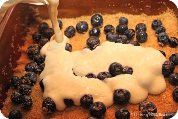 Lemon Blueberry Cheesecake Bars - Pouring the Filling Over the Blueberries | Cooking In Stilettos