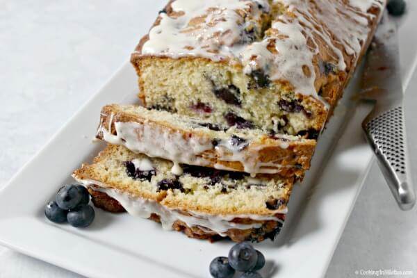 This Blueberries and Cream Quick Bread recipe from CookingInStilettos.com is bursting with fresh summer blueberries with hints of lemon and vanilla and drizzled with a sweet creamy vanilla glaze. | Quick Bread | Blueberry Bread | Summer | Blueberries | Greek Yogurt | Baking | Easy quick bread recipe