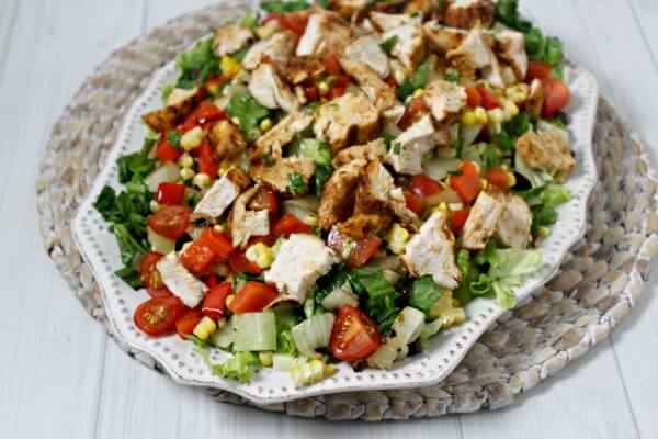 Grilled Southwestern Chicken Salad from CookingInStilettos.com brings the flavor with spice rubbed chicken, grilled veggies, crisp romaine lettuce & drizzled with a honey lime vinaigrette. This will be your go-to summer salad | Southwestern | Grilling | Chicken | Summer Salads | Dinner Salad