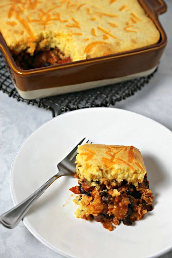 This Easy Chipotle Tamale Pie from CookingInStilettos.com is comfort food with a bit of sass. Lean ground turkey, tomatoes & spices are nestled under a cheesy cornbread crust and baked to perfection. Tamale Pie | Comfort Food | Mexican | Turkey | Healthy Recipe