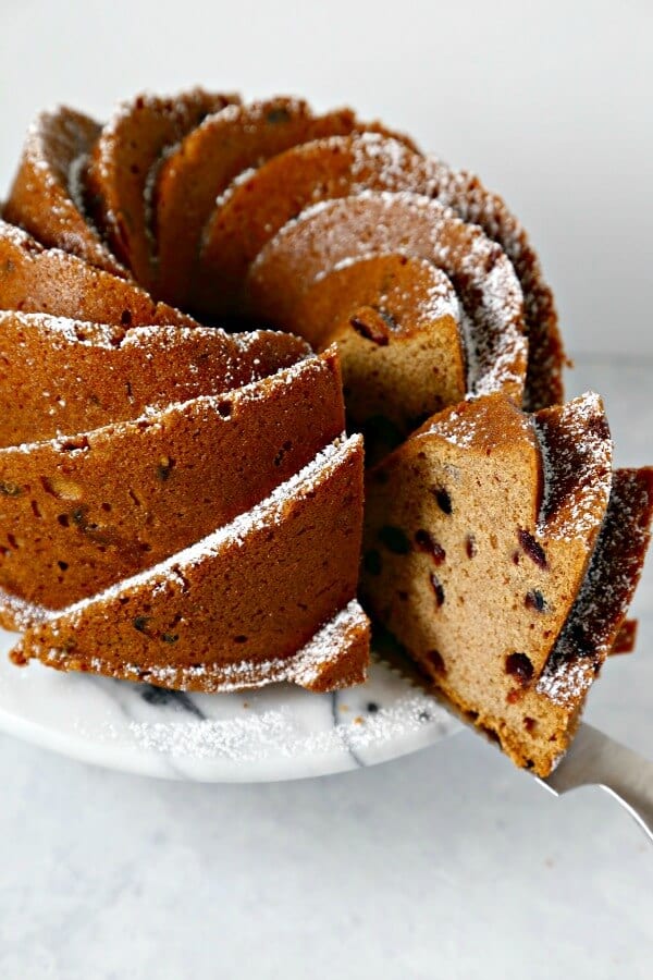 This Applesauce Cranberry Bundt Cake from CookingInStilettos.com will be a showstopper at your next weekend brunch. This moist rich applesauce cake studded with dried cranberries and spices will win rave reviews from your friends and family | @CookInStilettos