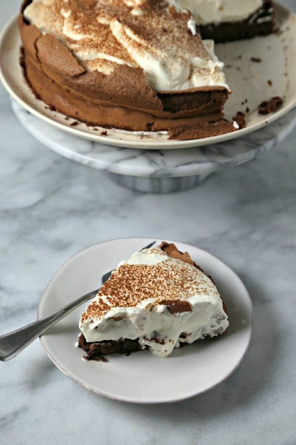 This Chocolate Cloud Cake from CookingInStilettos.com is a showstopper dessert! Rich flourless chocolate cake is dolloped with pillows of whipped cream - a heavenly treat indeed! Chocolate | Flourless Chocolate Cake | Gluten Free | Rich Dessert