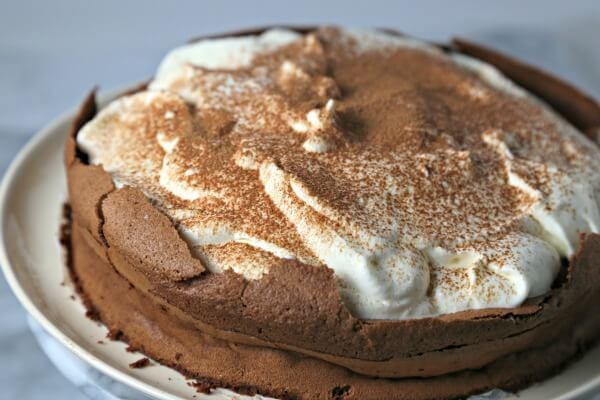 This Chocolate Cloud Cake from CookingInStilettos.com is a showstopper dessert! Rich flourless chocolate cake is dolloped with pillows of whipped cream - a heavenly treat indeed! Chocolate | Flourless Chocolate Cake | Gluten Free | Rich Dessert