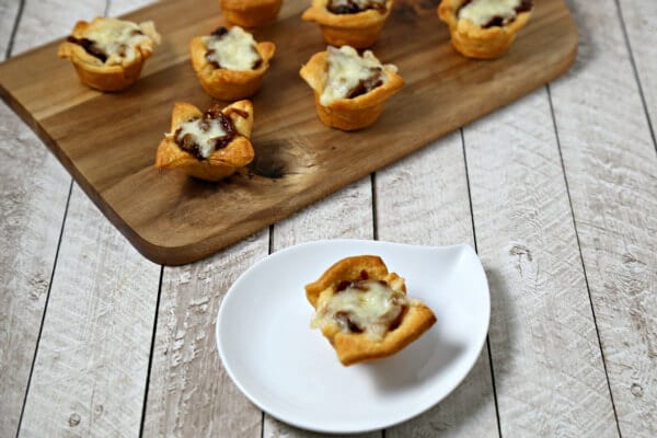 French Onion Bites from CookingInStilettos.com have the flavors of the classic soup in a chic appetizer. Buttery Pillsbury Crescent Roll dough is baked with richly caramelized onions and savory fontina cheese. | Appetizer | Caramelized Onions | French Onion Soup | Chic Appetizer | Comfort Food Recipe | Easy Entertaining