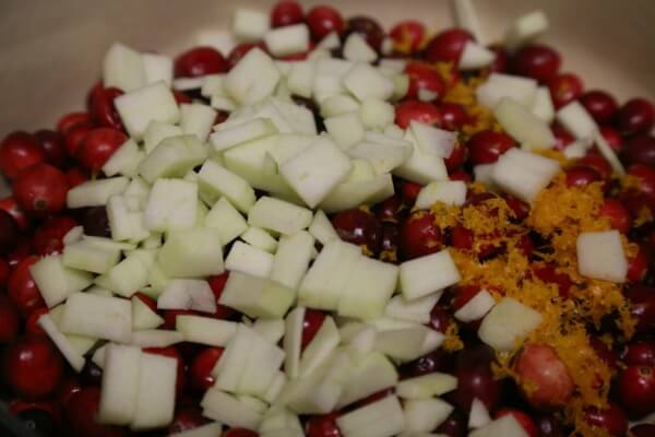 Homemade Cranberry Sauce with Orange and Apple - Adding the Fruit | CookingInStilettos.com