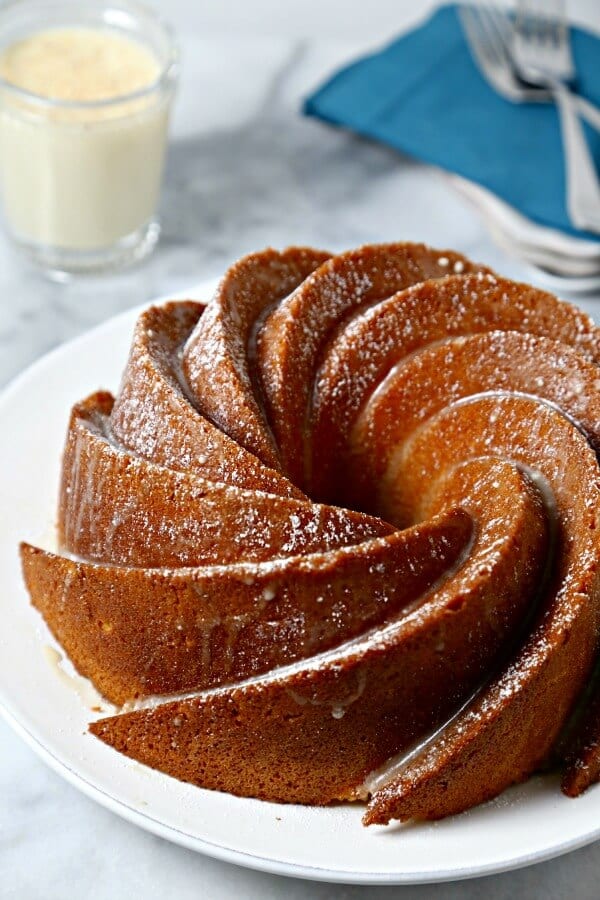 Bourbon Soaked Eggnog Cake from CookingInStilettos.com is a dessert showstopper. A moist rich eggnog cake with hints of spice and bourbon and drizzled with a bourbon eggnog glaze.