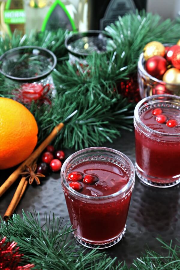 This Cranberry Honey Blossom Cocktail from CookingInStilettos.com is a festive cocktail for the holidays. Tart cranberries and sweet orange meld with tequila and a touch of spiced honey syrup for the perfect sip.