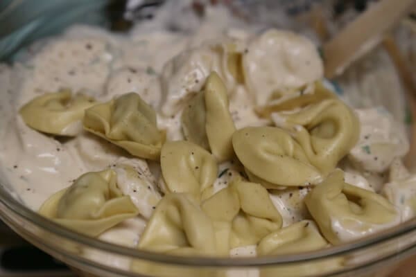 Easy No Boil Baked Tortellini - Mixing in the Tortellini | CookingInStilettos.com