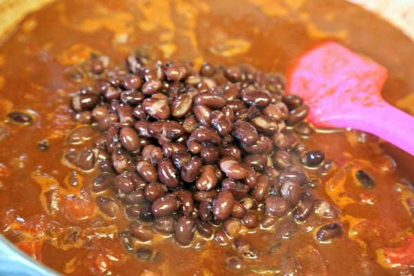 Baja Chicken Chili - Adding the Black Beans | CookingInStilettos.com