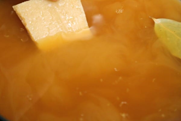 Lemon Chicken Noodle Soup - Adding the Parmesan Rind | CookingInStilettos.com
