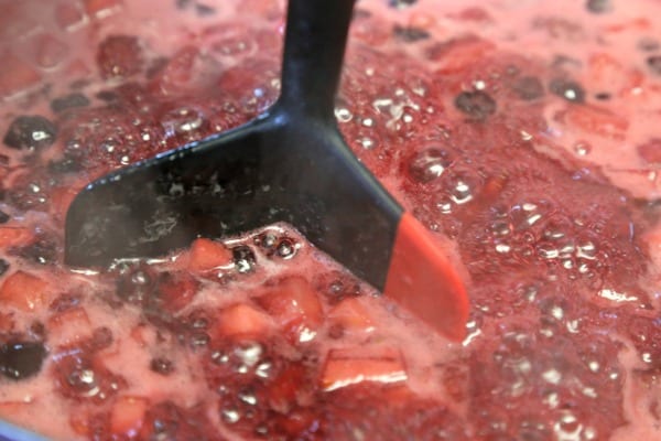 Easiest Ever Strawberry Jam - Mashing the Berries | CookingInStilettos.com
