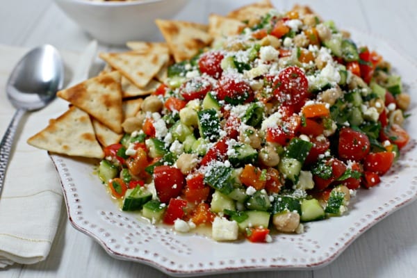 This chic and delicious Middle Eastern Chickpea Salad from CookingInStilettos.com is packed with protein-packed chickpeas and fresh veggies tossed in a lemon basil vinaigrette. This easy salad can be served as a side dish, main entree or even nestled in pita bread for the perfect lunch on the go | @CookInStilettos Easy Recipe | Vegetarian | Salad | Chickpea | Barefoot Contessa 