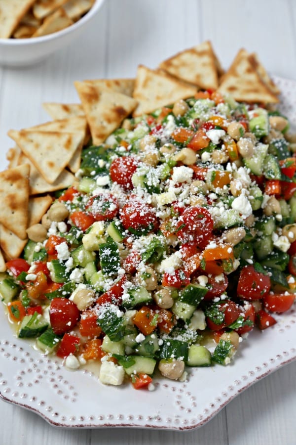 This chic and delicious Middle Eastern Chickpea Salad from CookingInStilettos.com is packed with protein-packed chickpeas and fresh veggies tossed in a lemon basil vinaigrette. This easy salad can be served as a side dish, main entree or even nestled in pita bread for the perfect lunch on the go | @CookInStilettos Easy Recipe | Vegetarian | Salad | Chickpea | Barefoot Contessa 