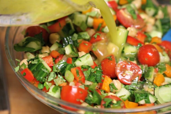 Middle Eastern Chickpea Salad - Mixing the Veggies with the Lemony Basil Vinaigrette | CookingInStilettos.com