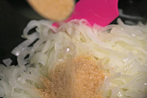 Pulled Pork with Caramelized Onions - Adding the Turbinado Sugar | CookingInStilettos.com