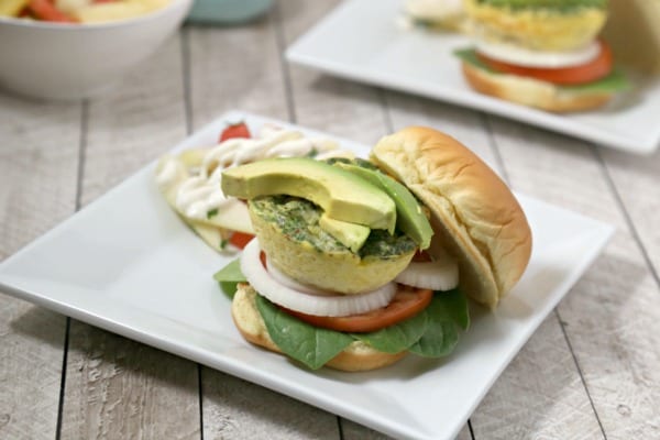 This Cheesy Breakfast Burger from CookingInStilettos.com is soon to be your favorite brunch recipe. A light as a feather quiche “burger” is nestled among fresh veggies in a pillowy bun for the perfect bite. | @CookInStilettos