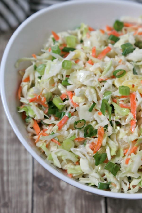 This easy Pineapple Slaw from CookingInStilettos.com will be a summertime favorite - sweet pineapple, spicy ginger & cabbage are tossed in a light yogurt dressing for the ultimate summer coleslaw | Cole Slaw | Pineapple | Healthy | BBQ | Cookout