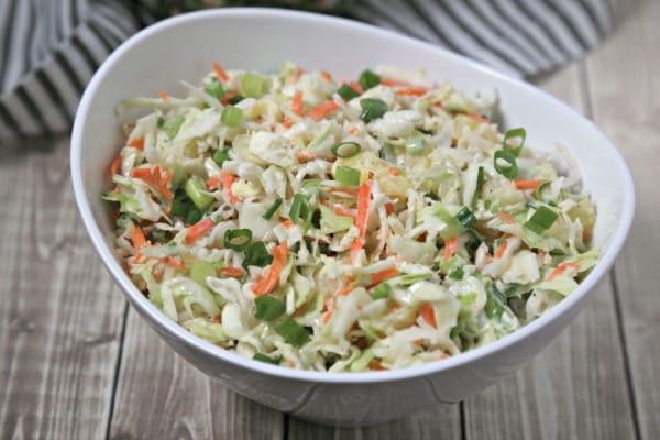 This easy Pineapple Slaw from CookingInStilettos.com will be a summertime favorite - sweet pineapple, spicy ginger & cabbage are tossed in a light yogurt dressing for the ultimate summer coleslaw | Cole Slaw | Pineapple | Healthy | BBQ | Cookout