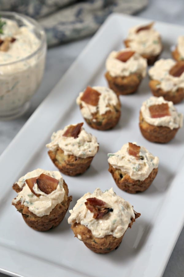 These bite-size Bacon Thyme Scones with Savory Whipped Ricotta from CookingInStilettos.com are a delicious bite for any party! Bacon and fresh thyme are baked into mini muffin scones with a herby cheesy whipped ricotta dolloped on top. What's not to love? | @CookInStilettos