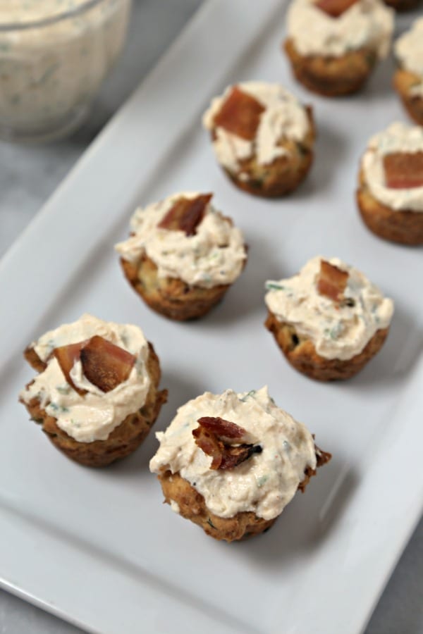 These bite-size Bacon Thyme Scones with Savory Whipped Ricotta from CookingInStilettos.com are a delicious bite for any party! Bacon and fresh thyme are baked into mini muffin scones with a herby cheesy whipped ricotta dolloped on top. What's not to love? | @CookInStilettos