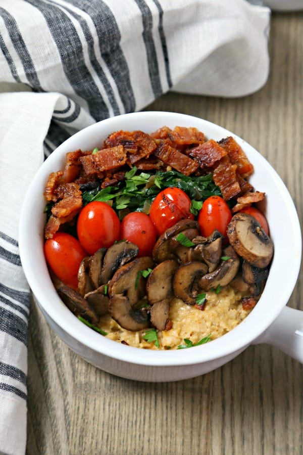 For your next brunch or when you want breakfast for dinner, make this Savory Oatmeal with Bacon, Spinach and Blistered Tomatoes from CookingInStilettos.com. This savory oatmeal recipe will be a chic and comforting favorite | @CookInStilettos