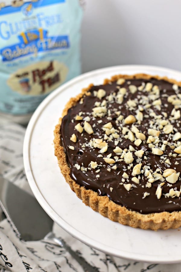 Gluten Free Chocolate Caramel Tart with Macadamia Nut Crust | CookingInStilettos.com