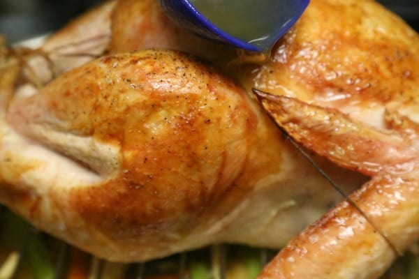 Mustard Maple Glazed Roast Turkey with Homemade Gravy- Basting with the buttery broth mixture | CookingInStilettos.com