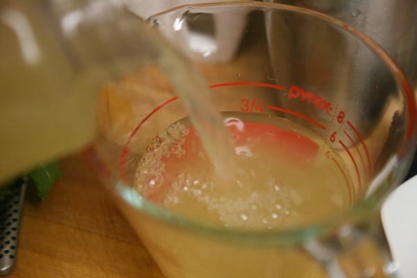 Tangerine Mojito- Pouring the Tangerine Lemonade | CookingInStilettos.com