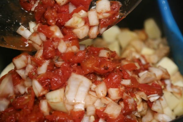 Slow Cooker Pork Tinga with Potatoes, Avocado and Fresh Cheese - Adding the Tomato Onion Mixture | CookingInStilettos.com