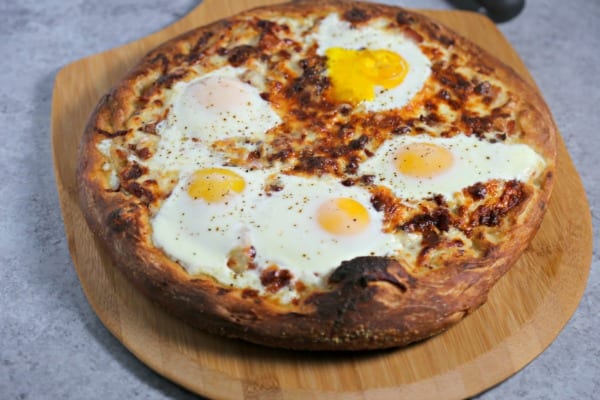 This Epic Bacon Croque Madame Pizza is the ultimate brunch pizza with layers of bacon, ham and cheese baked to perfection.  To take it over the top, bake a sunny side up egg (or a few) on it! Croque Madame | Homemade Pizza | Bacon Pizza | Bacon | Homemade Bechamel Sauce | Fontina | Gruyere | Cheese